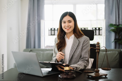 Beautiful asian woman lawyer working and gavel, tablet, laptop in front, Advice justice and law concept. in office.