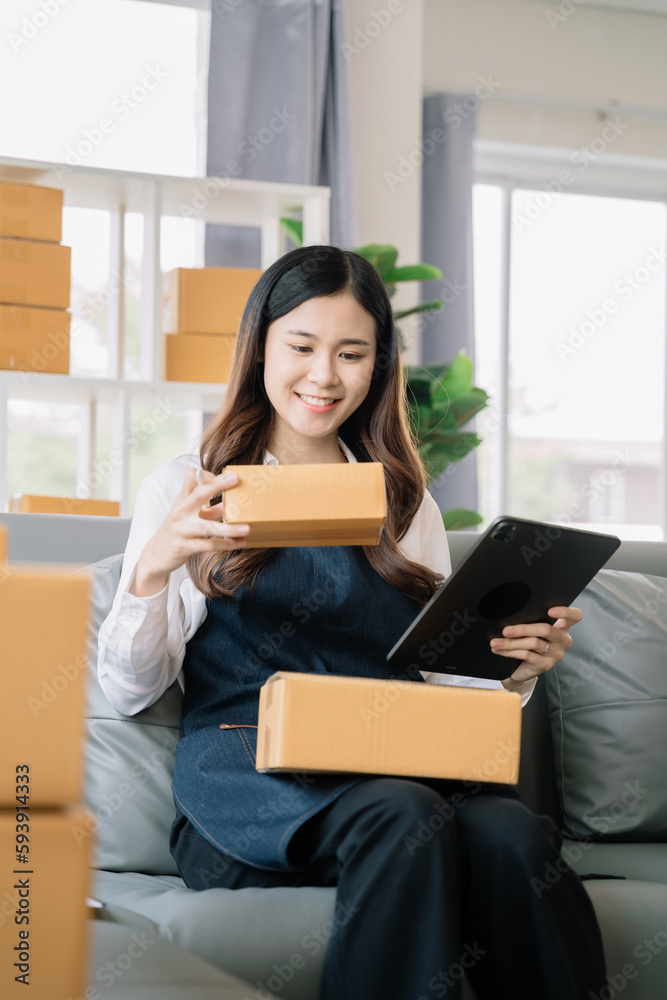 Portrait of a Small Business Startup, SME Owner, Female Entrepreneur work and check orders online. Online SME business idea. Portrait of a Small Business Startup, SME Owner, Female Entrepreneur work and check orders online. Online SME business idea.