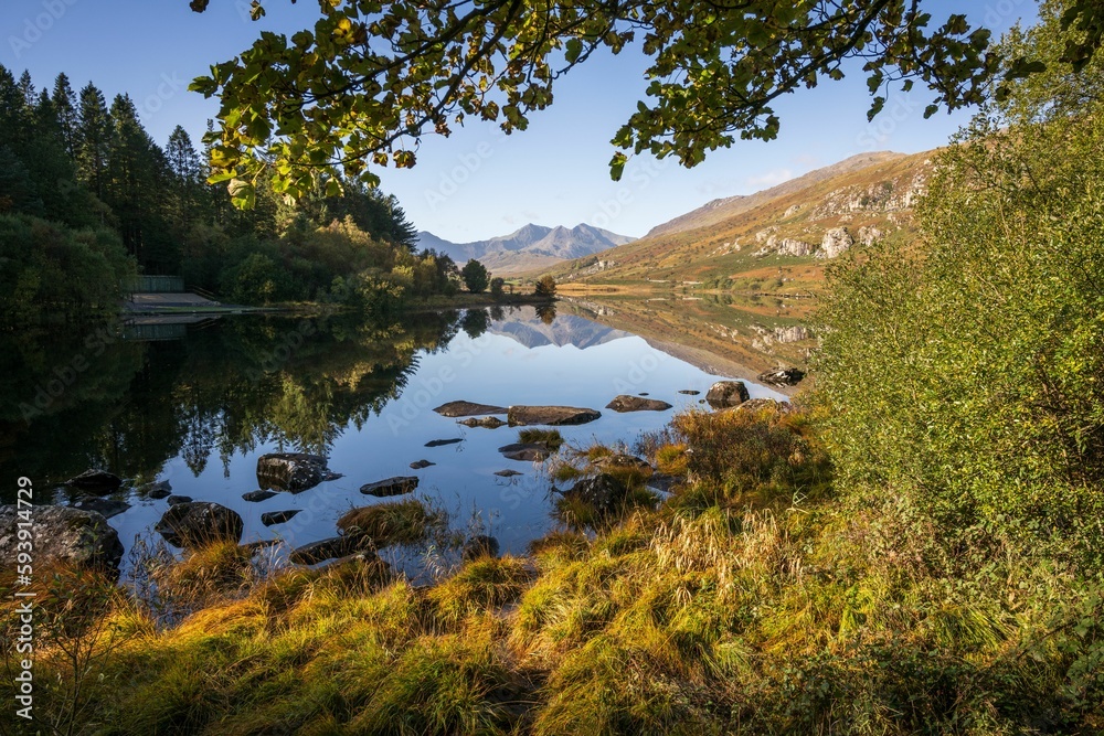 Morning sunrise view of a pond and greenery with the Snowdon mountain in the background Morning sunrise view of a pond and greenery with the Snowdon mountain in the background