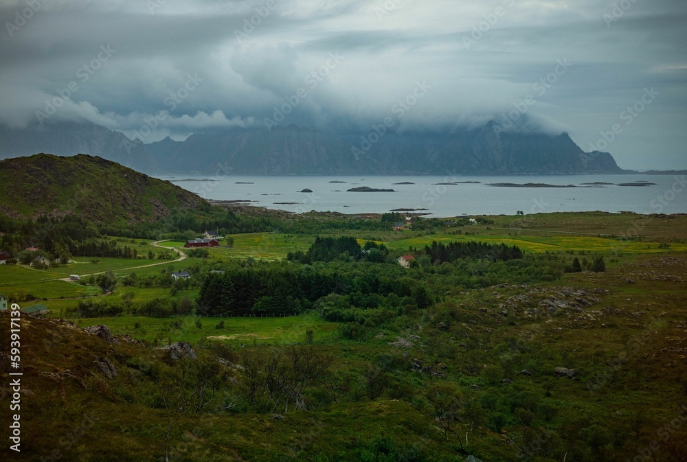 Aerial shot of a coastal village under a cloudy sky in Lofoten, Norway