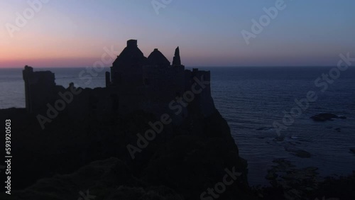 silhouette of Dunluce Castleon at sunset photo