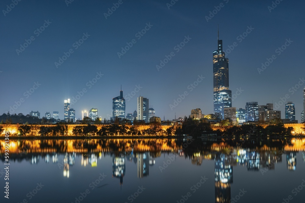 Beautiful view of a cityscape with a lake in the foreground at night