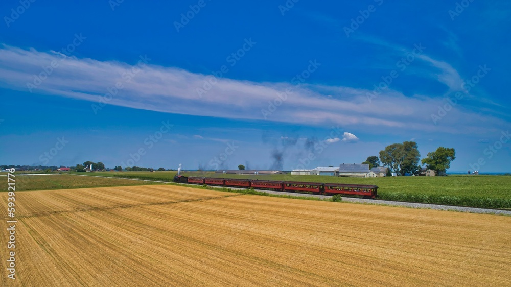 Aerial View of a Steam Passenger Train Approaching Traveling Through Farmlands