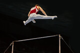 gymnast performing on horizontal bar competition artistic gymnastics, black background