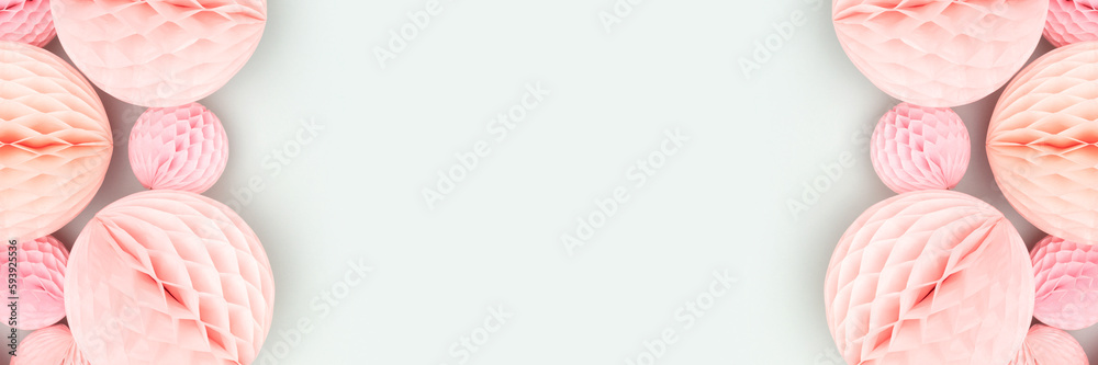 Banner with frame made of pink tissue paper balls on a blue background. Place for text. Banner with frame made of pink tissue paper balls on a blue background. Place for text.