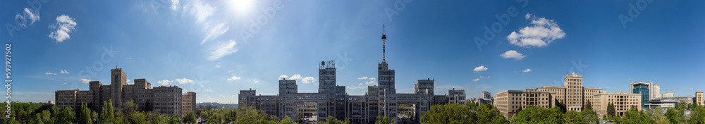 Aerial wide panorama on Derzhprom and Karazin National University buildings on Freedom Square with blue sunny sky in Kharkiv, Ukraine