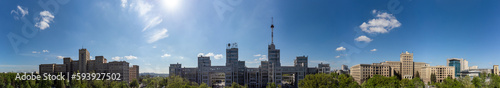 Aerial wide panorama on Derzhprom and Karazin National University buildings on Freedom Square with blue sunny sky in Kharkiv, Ukraine