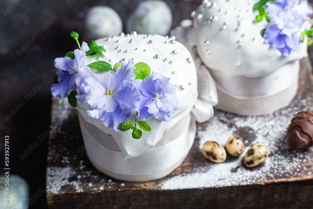 Easter cake with meringue and violets on a dark background Easter cake with meringue and violets on a dark background