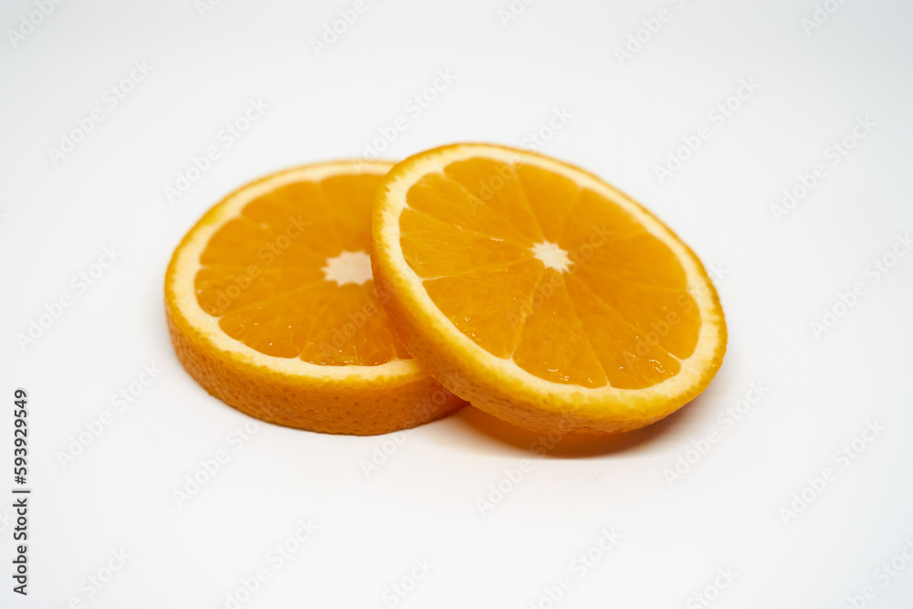Two slices of orange on white isolated studio background side view Two slices of orange on white isolated studio background side view