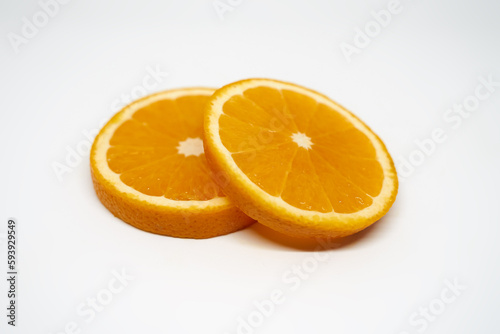Two slices of       orange on white isolated studio background side view