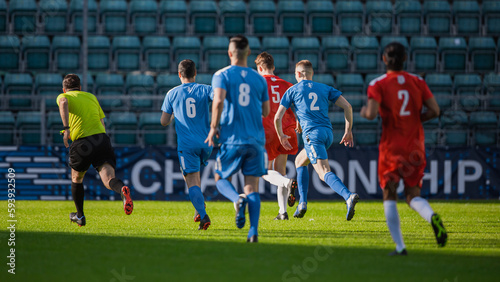Stadium Soccer Football Match International Championship. Blue And Red Team Defence Players Running Behind Forward, Defending Positions. World Tournament. Live Sports Broadcast TV Channel. © Gorodenkoff