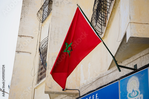 Red flag of Morocco waving in the wind background outside