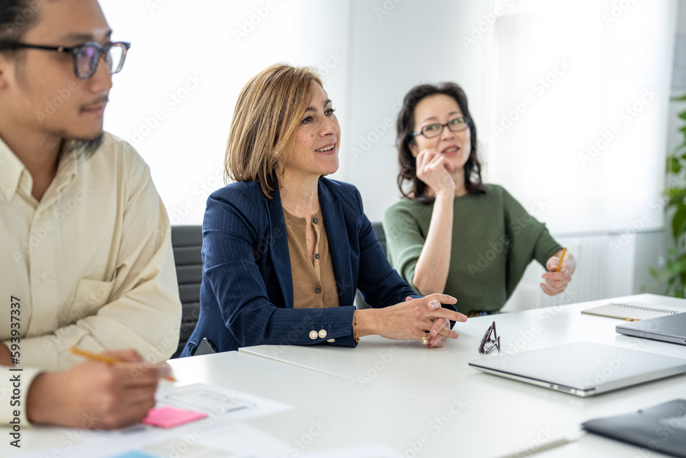 Happy and serene expressions of managers and colleagues at the meeting table, genuine and real business woman in the workplace Happy and serene expressions of managers and colleagues at the meeting table, genuine and real business woman in the workplace
