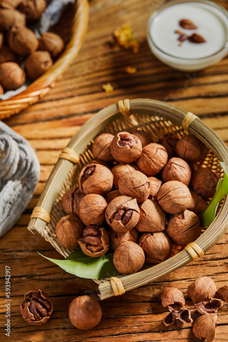 Carya illinoinensis (Wangenh.),Carya cathayensis Sarg,Walnuts are a recreational nut snack with a hard shell photo