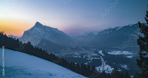 morning time lapse over city of banff with mountains during winter photo