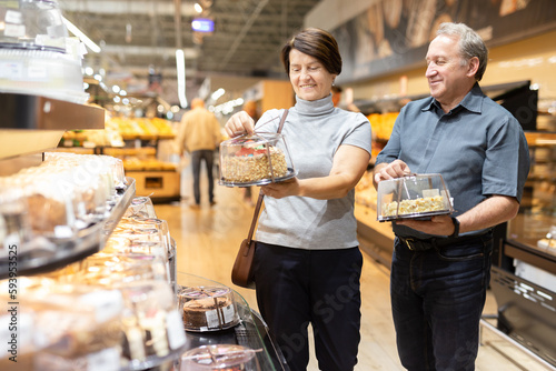 husband and wife choose cake in store for festive dinner