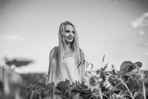 Fototapeta Naklejka Na Ścianę i Meble -  Grayscale shot of an attractive Caucasian female in the field