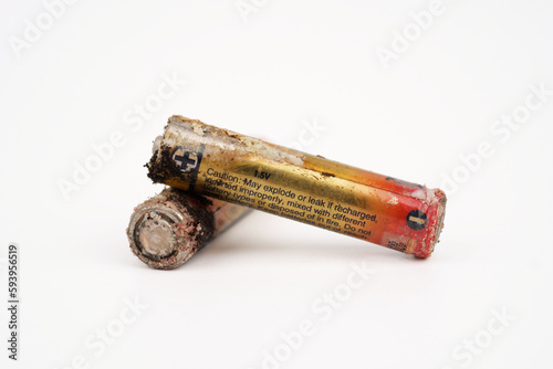 Damaged and corroded batteries isolated on white background.