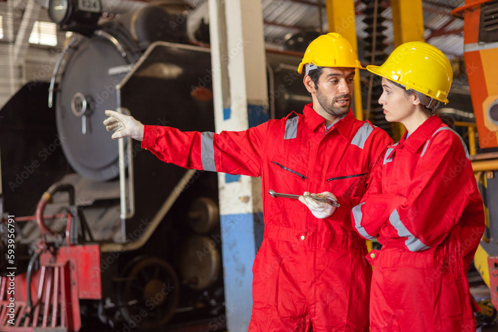 Engineer with worker talking together at factory Engineer with worker talking together at factory