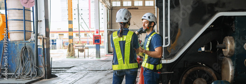 Engineer with worker talking together at factory