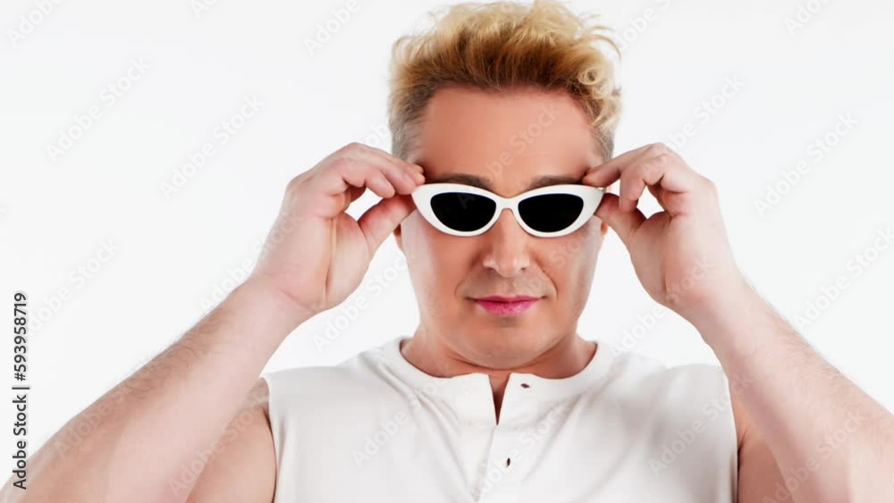 Happy, smile, man and confident expression with eye makeup in sunglasses. Mindset, empowerment, power and strength with positive emotional guy in studio isolated on white background. Happy, smile, man and confident expression with eye makeup in sunglasses. Mindset, empowerment, power and strength with positive emotional guy in studio isolated on white background.