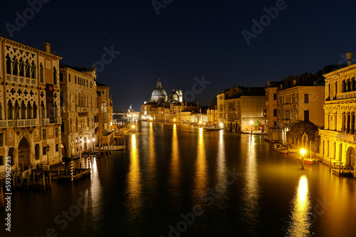 Venice  Italy  Night view of Venice Grand Canal with boats and Santa Maria della Salute church on sunset from Ponte dell Accademia bridge. Venice  Italy