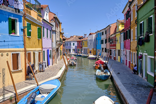Burano, Venice: Colorful houses of Burano island. Multicolored buildings on fondamenta embankment of narrow water canal with fishing boats and stone bridge, Venice Province, Veneto Region, Italy. © Matteo