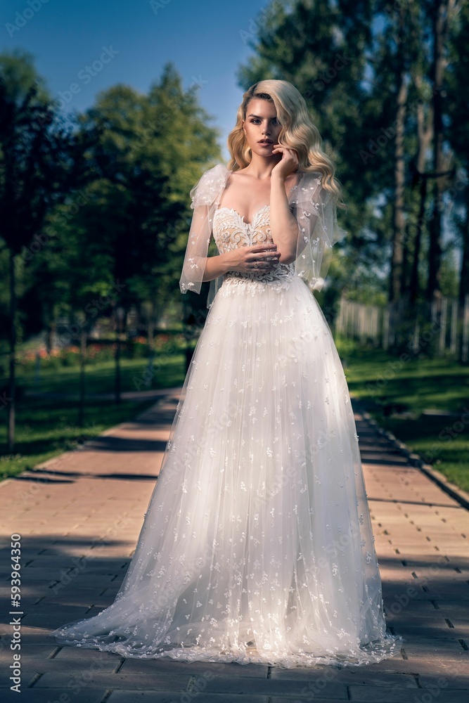 Vertical shot of the pretty blonde woman wearing a bride's dress Vertical shot of the pretty blonde woman wearing a bride's dress