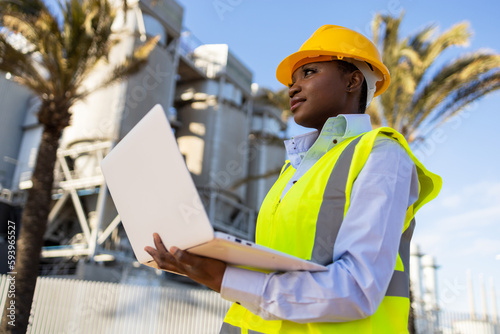 Black female engineering supervisor with laptop