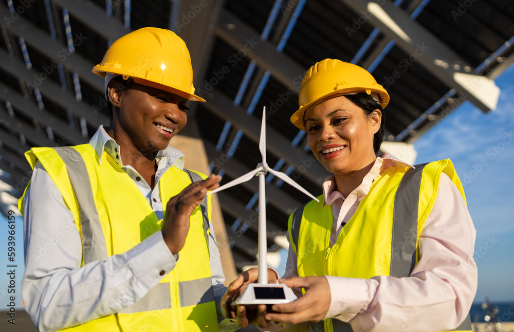 Black engineers with wind turbine on construction site Black engineers with wind turbine on construction site