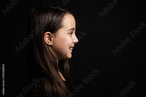 portrait of a child close-up, little girl on a black background