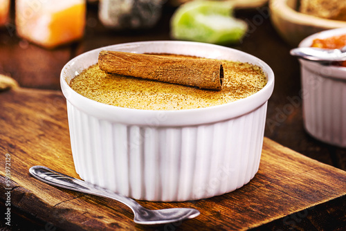 Corn sweet or pudding called Curau, jimbelê or hominy, with rural sweets in the background. Typical sweets from Brazilian June festivals