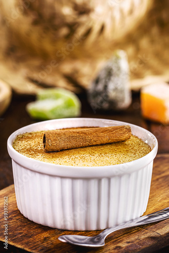 Corn sweet or pudding called Curau, jimbelê or hominy, with rural sweets in the background. Typical sweets from Brazilian June festivals