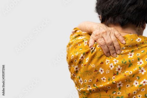 Sick senior woman with back neck and shoulders pain on the joint and muscle. Close-up of wrinkled hands rubbing their neck-collar area, osteoarthritis, neurological diseases. Medicine concept photo