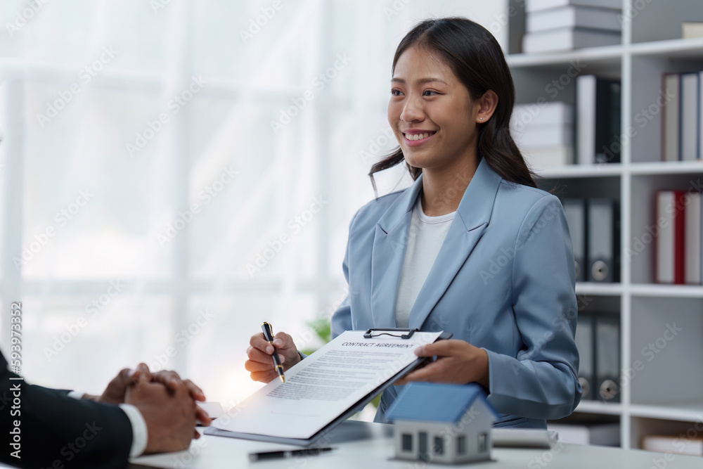 Close up Business people or Real Estate agent explain signing agreement for sale house to client. Property, Insurance, Broker concept Close up Business people or Real Estate agent explain signing agreement for sale house to client. Property, Insurance, Broker concept