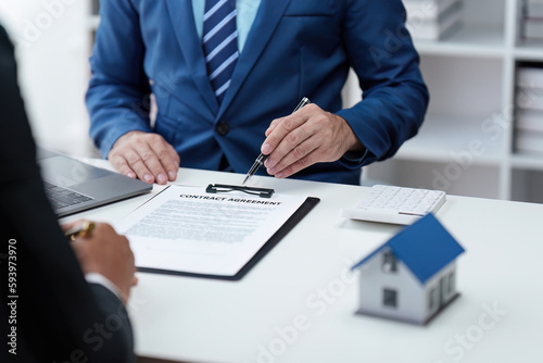 Close up Business people or Real Estate agent explain signing agreement for sale house to client. Property, Insurance, Broker concept