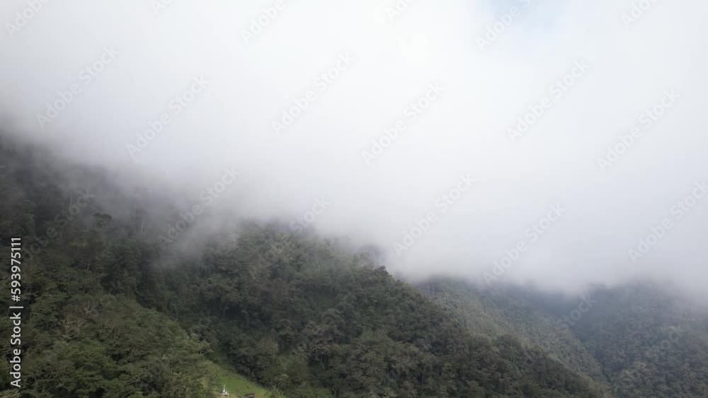 Mist Over the Green Mountains full of Trees and a Small House in the Middle of Them Mist Over the Green Mountains full of Trees and a Small House in the Middle of Them