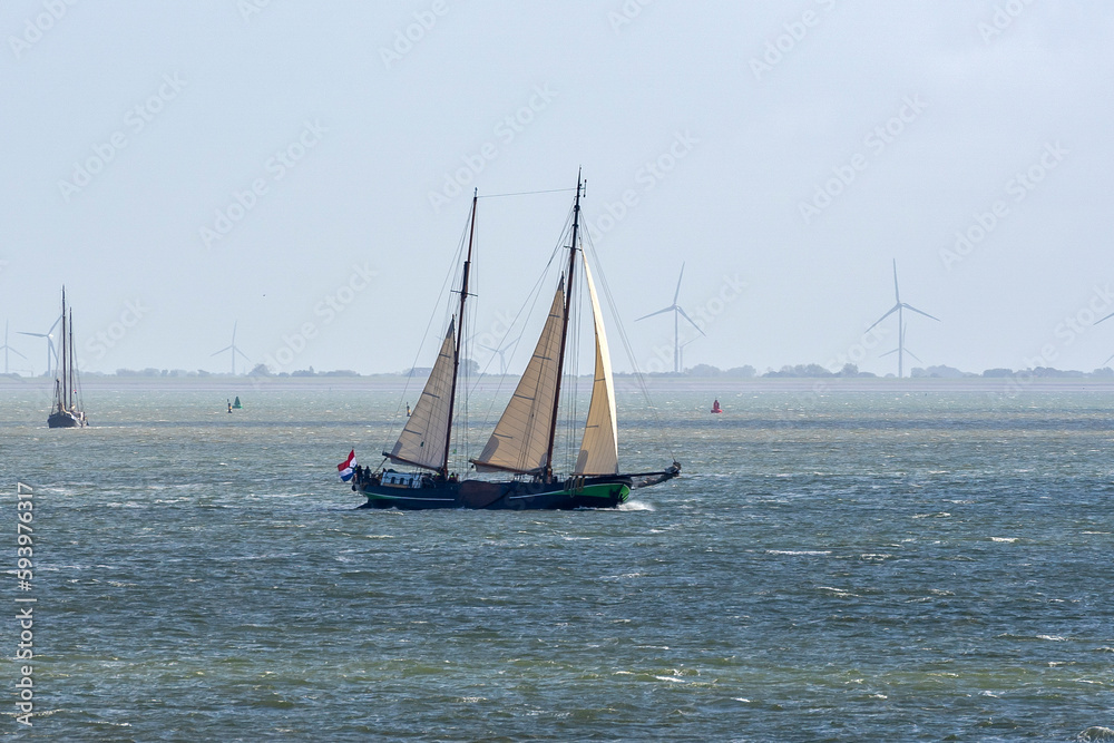 During a sunny but windy autumn day, several old sailing ships sail on the water of the Wadden Sea between Vlieland and the mainland near Harlingen, the Netherlands During a sunny but windy autumn day, several old sailing ships sail on the water of the Wadden Sea between Vlieland and the mainland near Harlingen, the Netherlands