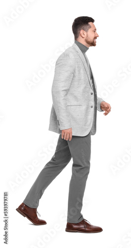 Handsome bearded businessman walking on white background