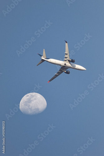 airplane passing by the moon