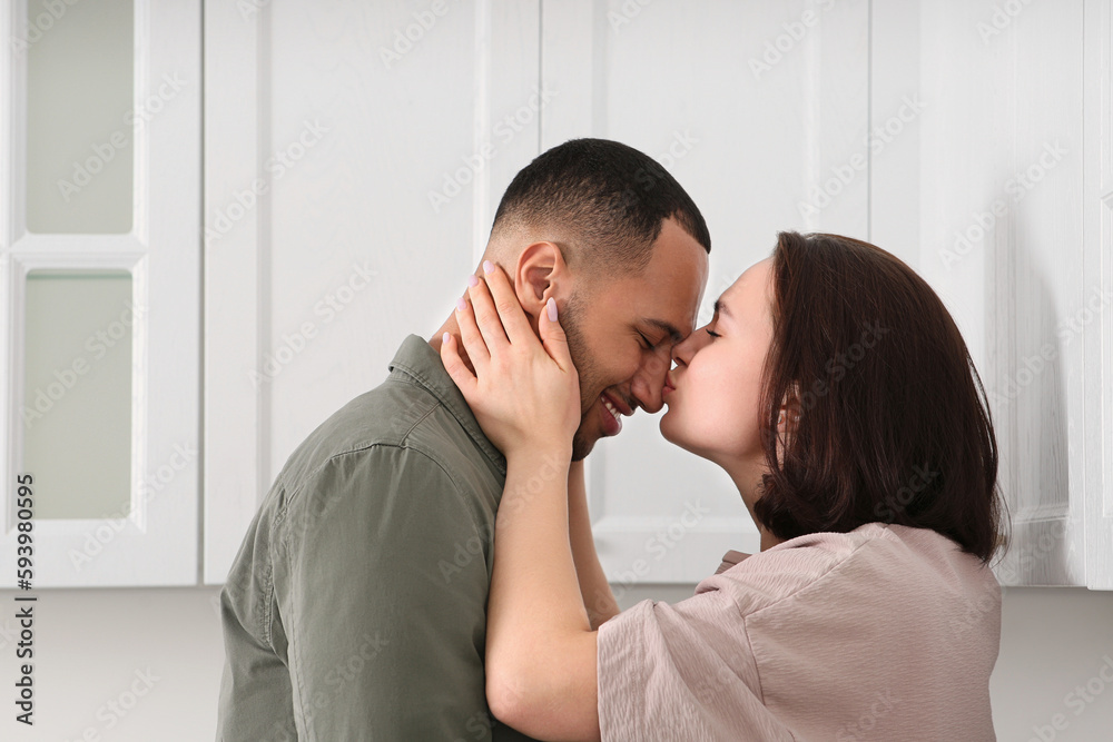 Dating agency. Woman kissing her boyfriend indoors Dating agency. Woman kissing her boyfriend indoors