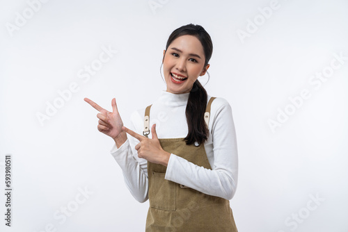 Happy young Asian woman pointing with finger at copy space isolated on white background.