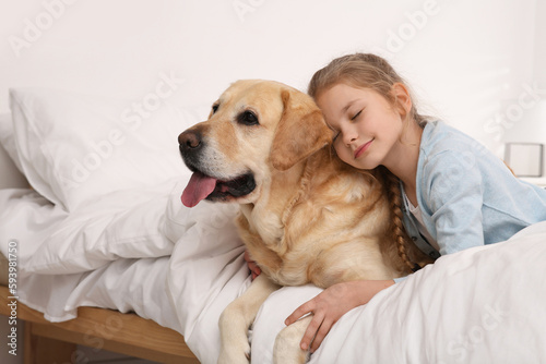 Young girl with her adorable dog on bed at home. Space for text