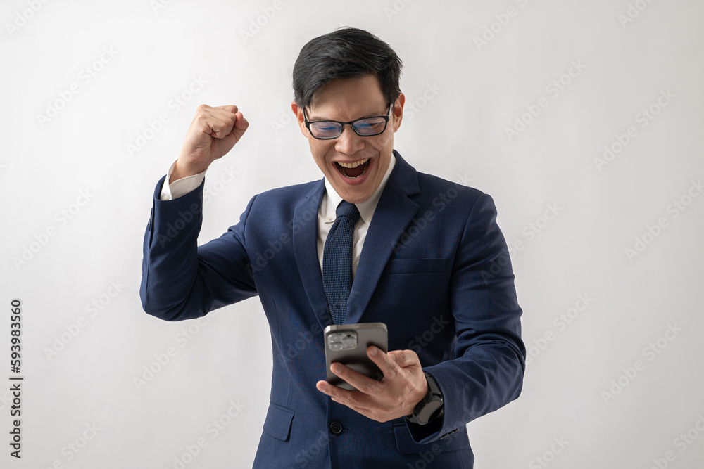 Portrait of confident Asian businessman in glasses using smartphone and doing victory gesture isolated on white background Portrait of confident Asian businessman in glasses using smartphone and doing victory gesture isolated on white background