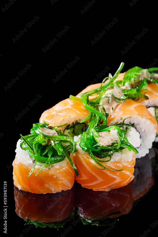 sushi roll with cream cheese philadelphia salmon cucumber chukka on a black mirror background sushi roll with cream cheese philadelphia salmon cucumber chukka on a black mirror background