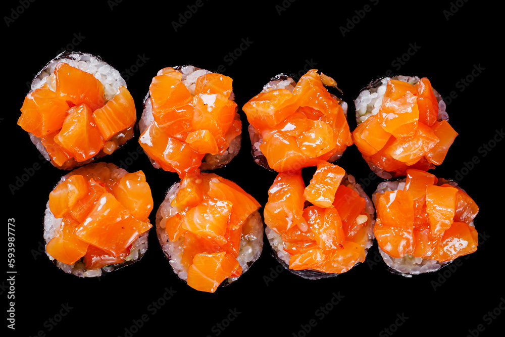sushi roll maki New York with cubes of salmon on a black mirror background sushi roll maki New York with cubes of salmon on a black mirror background