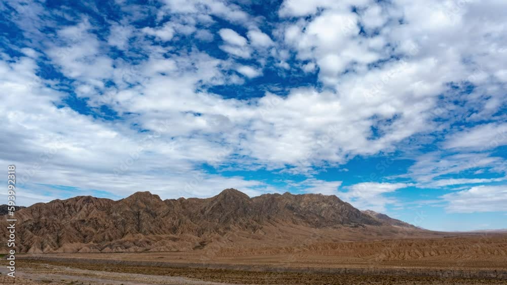 Timelapse video of the desert mountains with blue sky in the background Timelapse video of the desert mountains with blue sky in the background