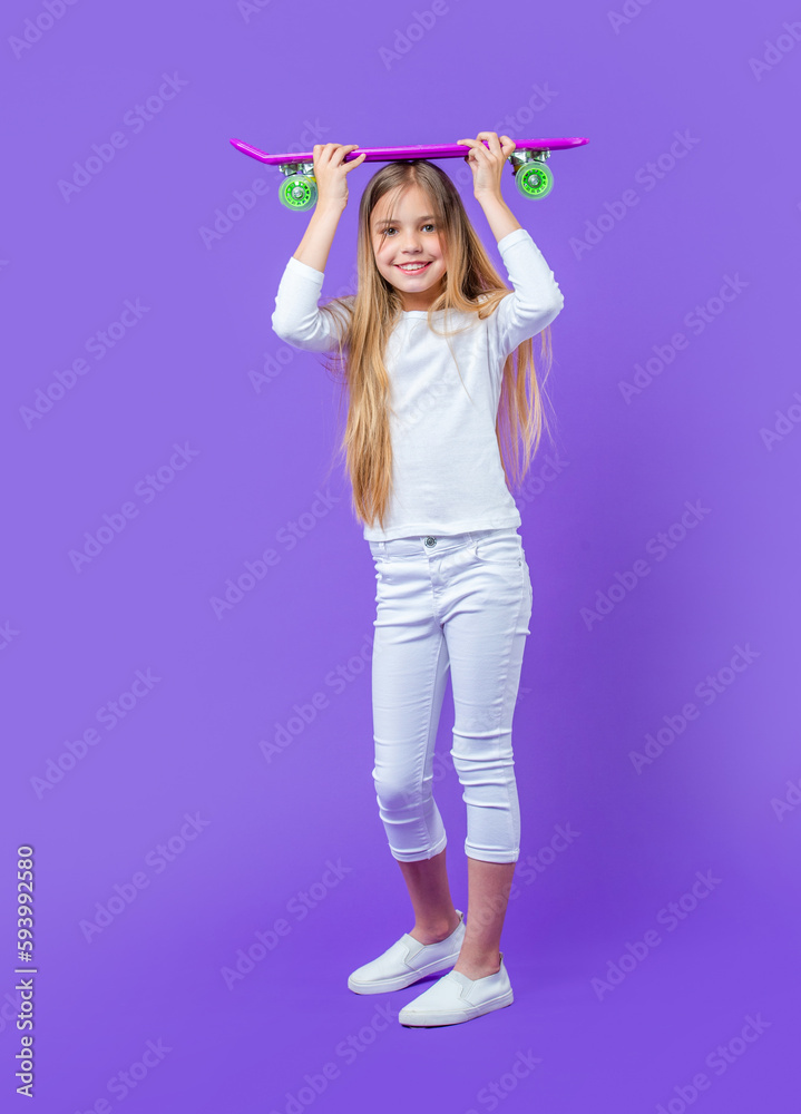teen girl skateboarder isolated on purple. teen girl skateboarder in studio. teen girl skateboarder isolated on purple. teen girl skateboarder in studio.