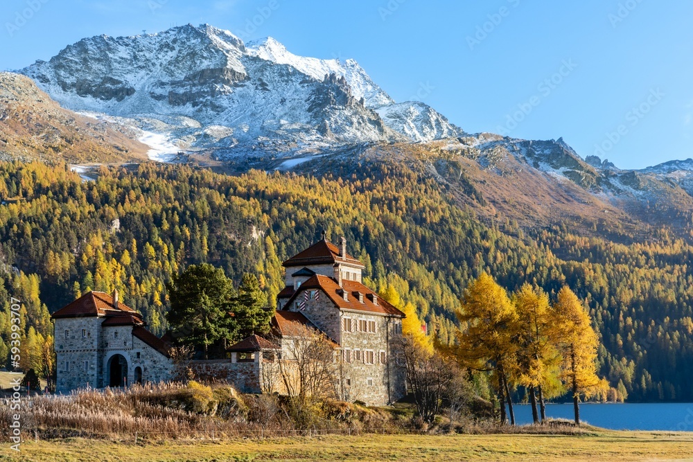 Scenic view of the historic Crap da Sass castle surrounded by autumn trees and mountains
