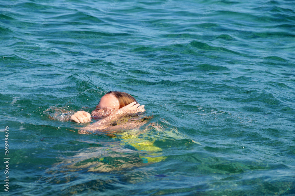 drowning choking girl in the sea close up